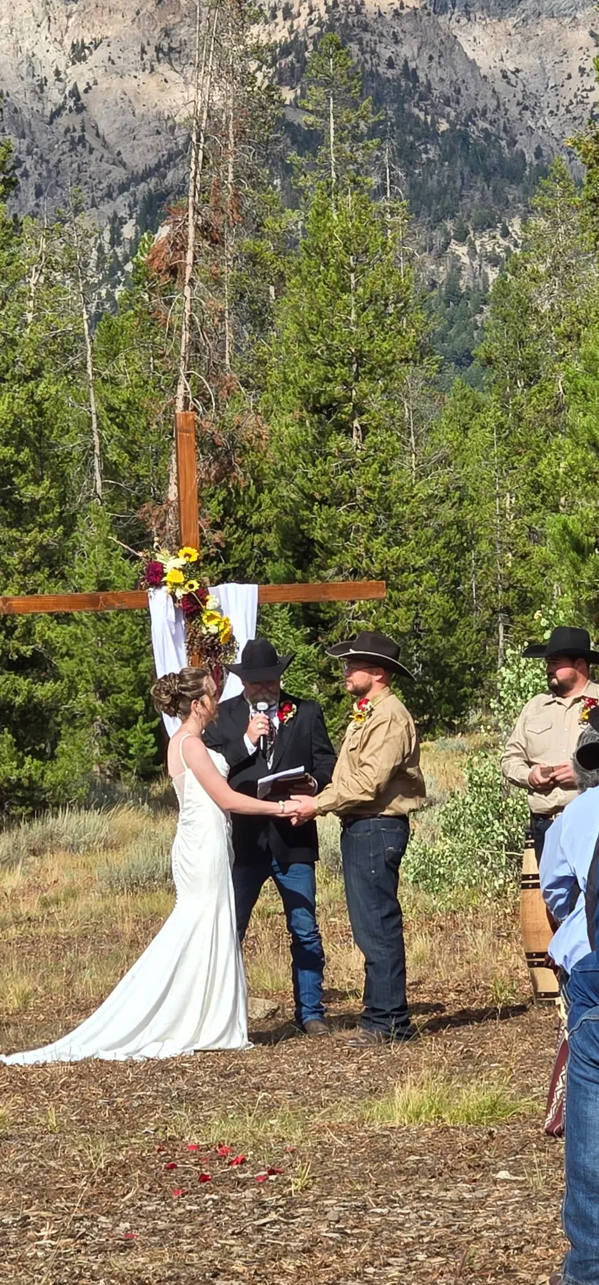 Kevin Capson officiating an outdoor wedding ceremony in a mountain forest setting